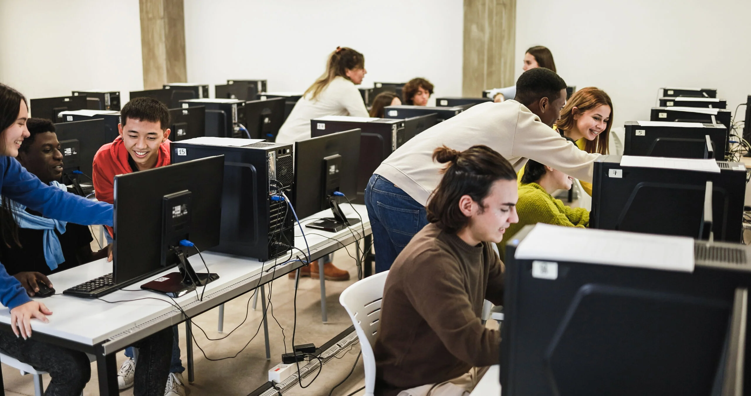 Young students using personal computer inside university IT clas